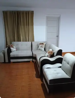 a living room with a couch and a chair at Departamento Acogedor en Surco in Lima