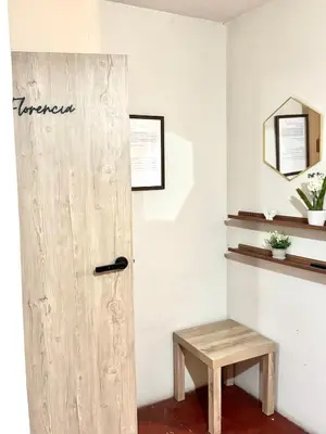 a room with a wooden door and a bench at Florencia Lodgement in Lima