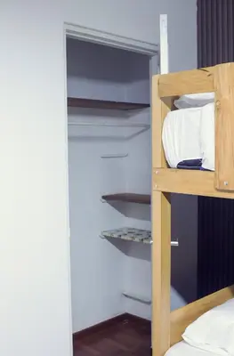 a bunk bed with white pillows in a room at Gutierrez Hostel in Lima