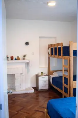 a bedroom with two bunk beds and a fireplace at Gutierrez Hostel in Lima