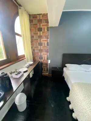 a hotel room with a bed and a sink at Habitaciones Independientes Av Larco in Lima