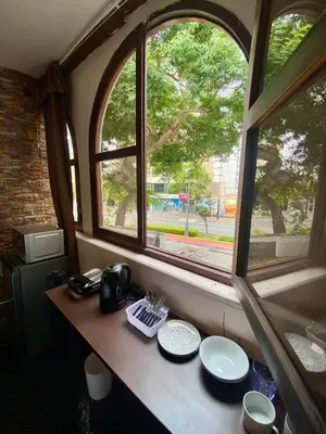 a table with two plates and two windows at Habitaciones Independientes Av Larco in Lima