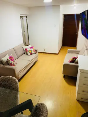 a living room with a couch and a table at Departamento Excelente Ubicacion in Lima
