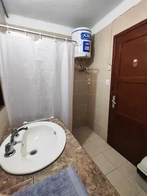 a bathroom with a sink and a shower at Habitación céntrica con vistas Larco in Lima