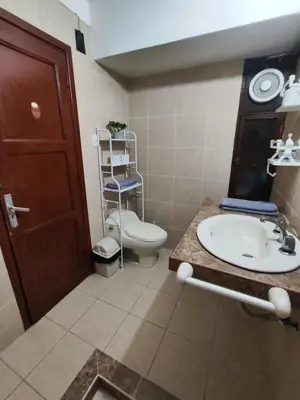 a bathroom with a toilet and a sink and a mirror at Céntrica habitación con vistas Miraflores in Lima