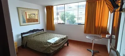 a bedroom with a bed and a window at Hostal Cesar Alberto in Lima