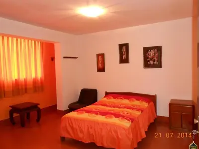a bedroom with a bed and a chair in it at Hostal Cesar Alberto in Lima