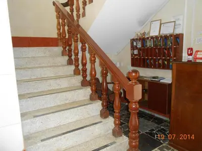 a staircase in a house with wooden railings at Hostal Cesar Alberto in Lima
