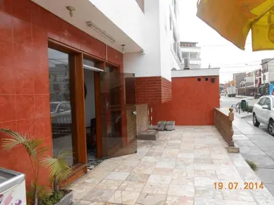 a building with a glass door on a street at Hostal Cesar Alberto in Lima