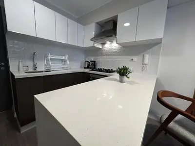 a kitchen with white cabinets and a white counter top at Brand new apartment in Miraflores in Lima