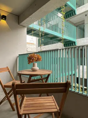 a table and a chair with a vase on it at Barranco Breeze Loft Apartments by Geko in Lima