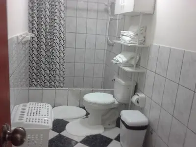 a small bathroom with a toilet and a shower at Modern Apartmen Furnished in Lima Near the Airport in Lima