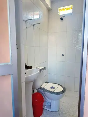 a small bathroom with a toilet and a sink at Departamento completo cerca de la Plaza ,cocina equipada y vista a la ciudad in Ayacucho