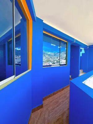 a blue room with a view of a city at Departamento completo cerca de la Plaza ,cocina equipada y vista a la ciudad in Ayacucho