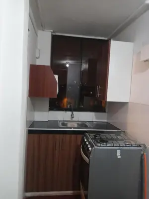 a small kitchen with a stove and a sink at Studio with kitchen and Bathroom Near The Airport in Lima