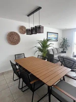 a dining room with a wooden table and chairs at Comfortable duplex - Punta Hermosa in Punta Hermosa