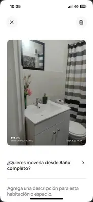 a bathroom with a white sink and a shower at Minidepa Ecléctico in Lima