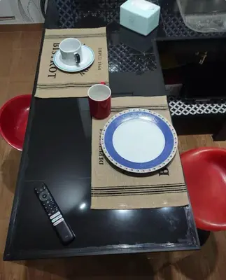 a table with a plate and a remote control on it at Minidepa Ecléctico in Lima