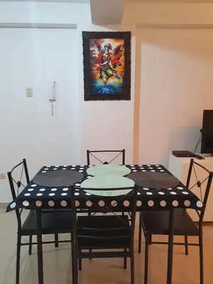 a dining room table with chairs and a painting on the wall at Your 2nd home in residential area in Cusco