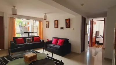 a living room with a couch and a table at Your 2nd home in residential area in Cusco