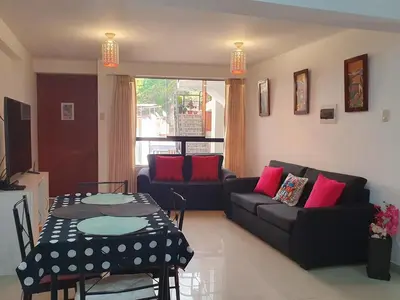 a living room with a table and a couch at Your 2nd home in residential area in Cusco