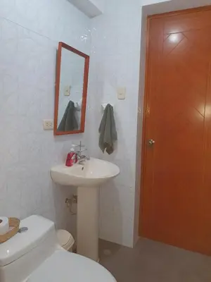 a bathroom with a toilet and a sink and a mirror at Your 2nd home in residential area in Cusco
