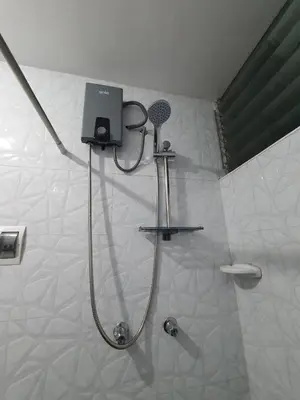a shower with a shower head in a bathroom at Your 2nd home in residential area in Cusco