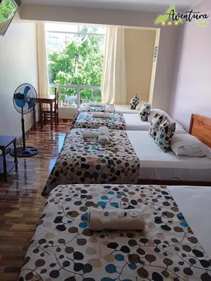 a group of four beds in a room at Destino Aventura Peru in La Merced