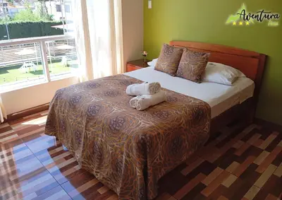 a bedroom with a bed with two towels on it at Destino Aventura Peru in La Merced