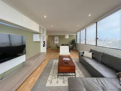 a living room with a couch and a tv at Sky Flatt 2BR by Geko in Lima