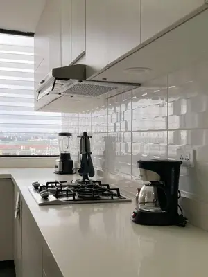 a kitchen with a stove top with a coffee maker on it at Sky Flatt 2BR by Geko in Lima