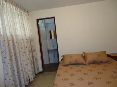 a bedroom with a bed with a curtain and a mirror at Hotel Estación Central in Lima