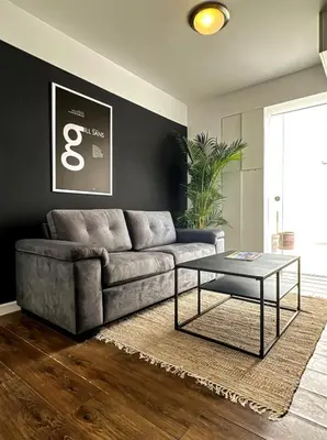 a living room with a couch and a table at The Snake 1BR by Geko in Lima
