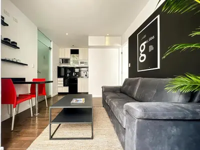 a living room with a couch and a table at The Snake 1BR by Geko in Lima