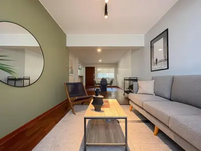 a living room with a couch and a table at Coco 3BR by Geko in Lima
