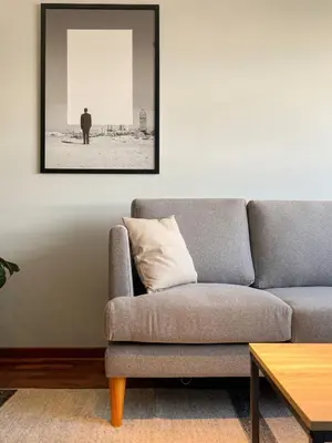 a living room with a couch and a picture on the wall at Coco 3BR by Geko in Lima