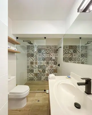 a white bathroom with a toilet and a sink at Coco 3BR by Geko in Lima