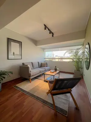 a living room with a couch and a table at Coco 3BR by Geko in Lima
