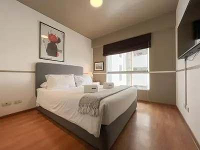 a bedroom with a large bed and a window at Barranco Sailor Apartment by Geko in Lima