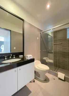 a bathroom with a toilet and a sink and a shower at Barranco Sailor Apartment by Geko in Lima