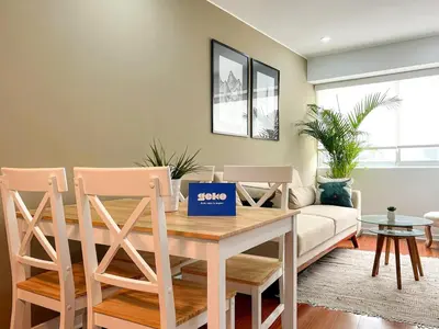a dining room with a table and chairs at The Bird 2BR by Geko in Lima