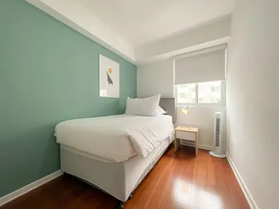 a small bedroom with a bed and a window at The Bird 2BR by Geko in Lima