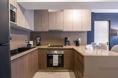 a kitchen with white cabinets and a counter top at Rivera Navarrete by Geko in Lima