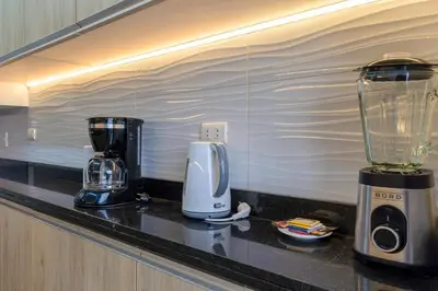 a kitchen counter with a blender and a coffee maker at Caoba 3BR by Geko in Lima