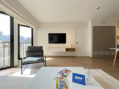 a living room with a chair and a television at Syberia 2BR by Geko in Lima
