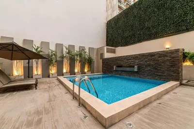 a swimming pool in the middle of a building at Midnight District Apartment by Geko in Lima