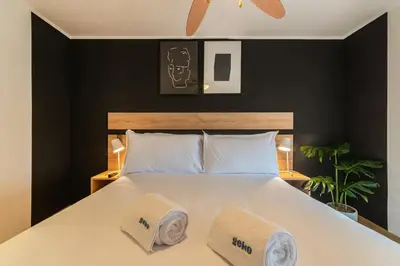a bedroom with a large white bed with two pillows at Midnight District Apartment by Geko in Lima
