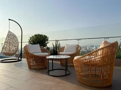 a group of chairs and a table on a balcony at Studio 4 by Geko in Lima