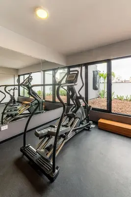 two exercise bikes in a gym with a window at Soho by Geko in Lima