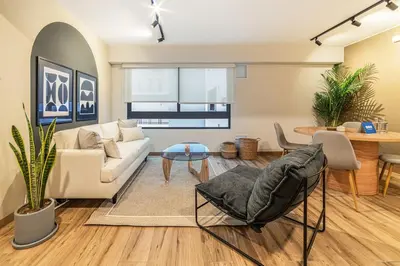a living room with a couch and a table at Soho by Geko in Lima